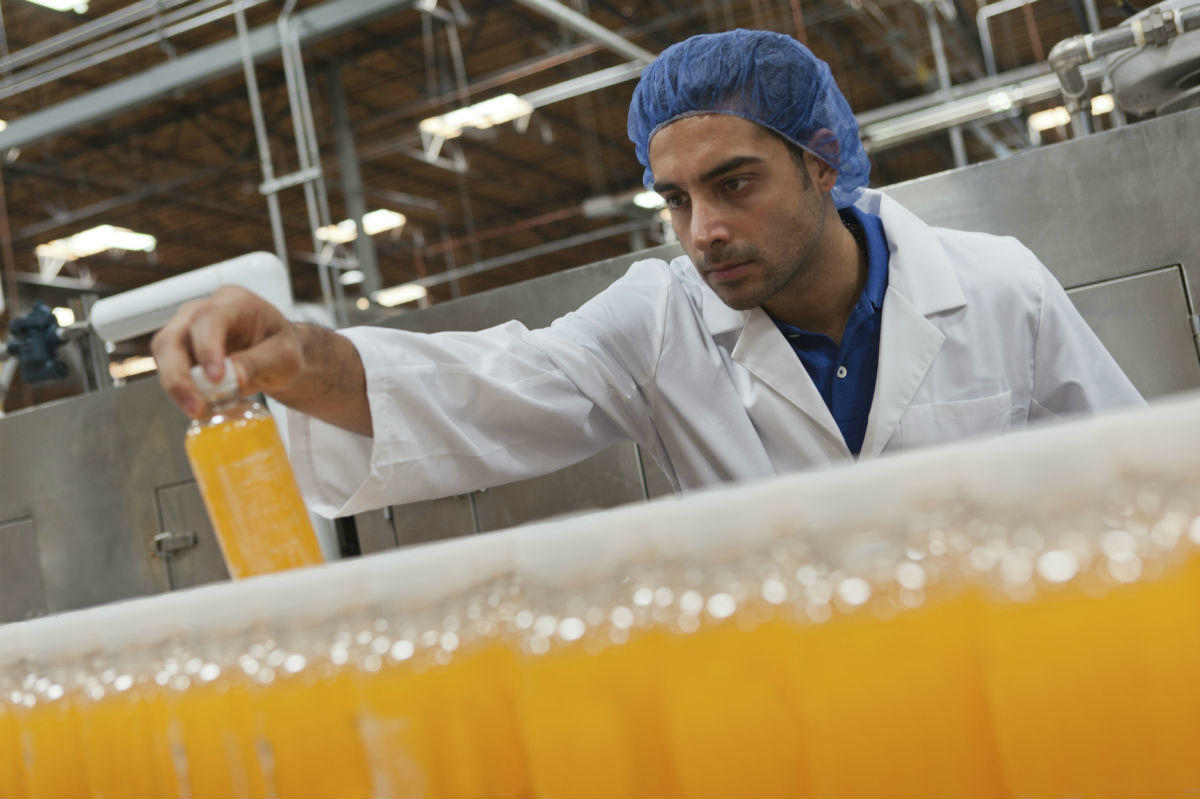 Factory worker operating machinery in a manufacturing plant