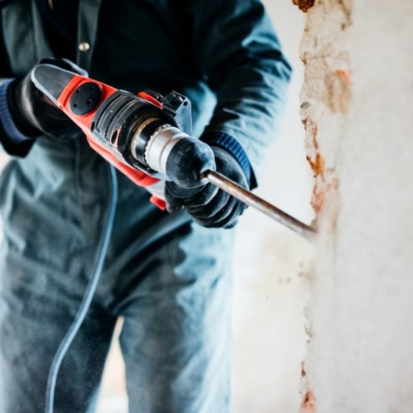 Missouri workers using a hammer drill