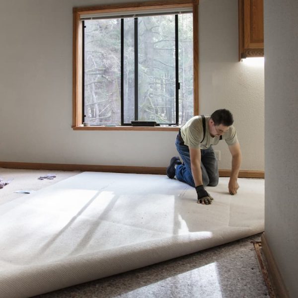 a Missouri worker laying carpet