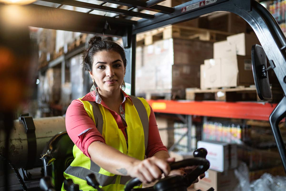 Warehouse worker moving freight on a loading=