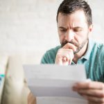 injured worker looking at insurance denial letter